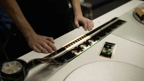 Two strips of film side by side showing the IMAX 70mm is at least twice the height of standard 35mm film