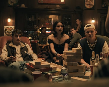 Two men and a woman playing giant jenga