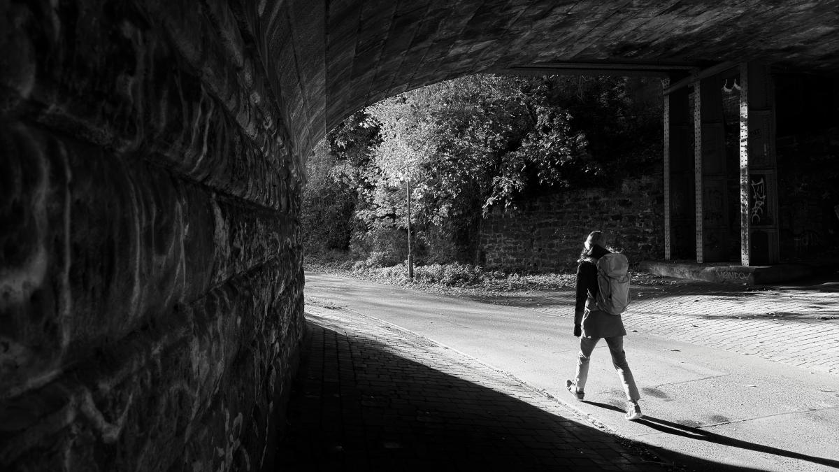 a black-and-white image of a person mid-stride