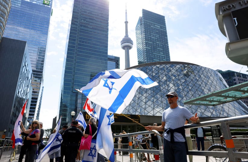 Counterprotesters hold Israeli flags during a protest outside the screening of the documentary ''The Road Between Us: The Ultimate Rescue'' about Hamas’s October 7 massacre, at the Toronto International Film Festival (TIFF) in Toronto, Ontario, Canada September 10, 2025.