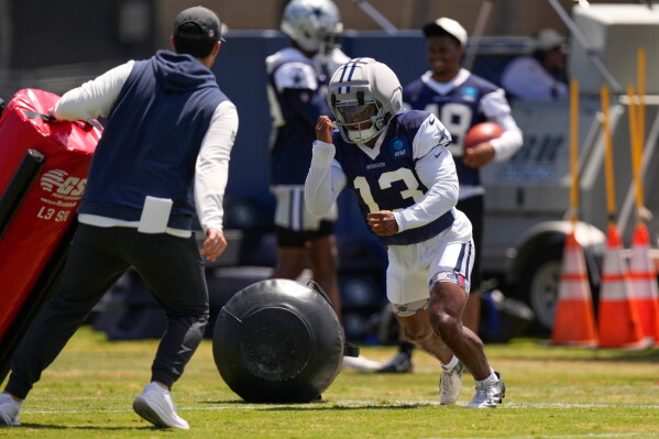 Dallas Cowboys defensive back Caleb Downs, right, runs a drill during the NFL football team's training camp, Tuesday, Aug. 4, 2026, in Oxnard, Calif. (AP Photo/Mark J. Terrill)