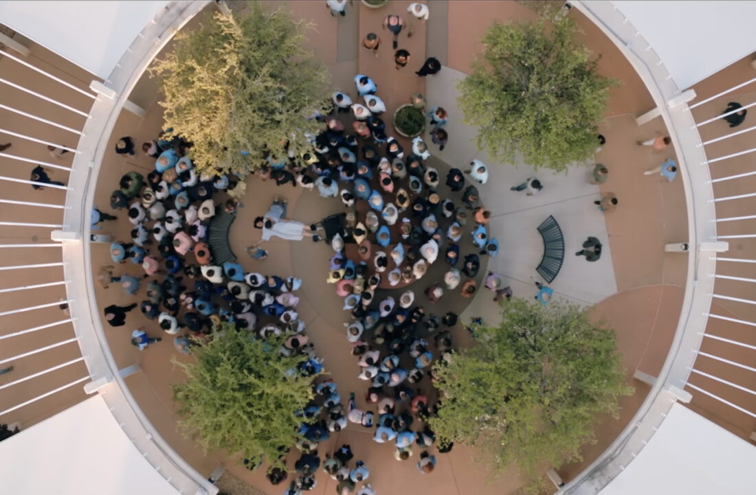 Overhead shot of the Joined looking over a hurt Zosia in Pluribus