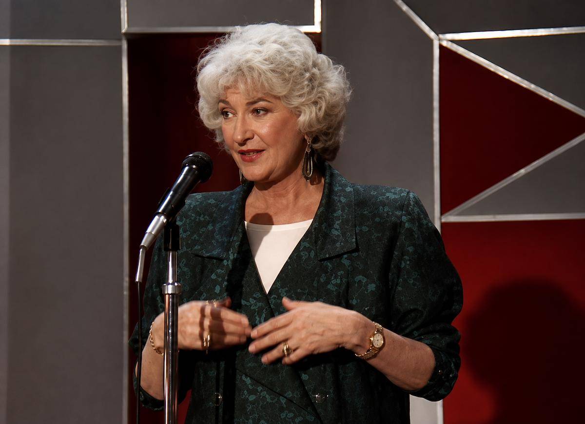 Bea Arthur speaking with a micrphone for a scene in The Golden Girls.  -