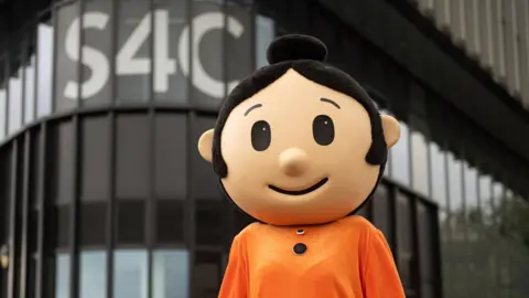 S4C A person wearing a Sali Mali costume, standing outside the S4C headquarters in Carmarthen.