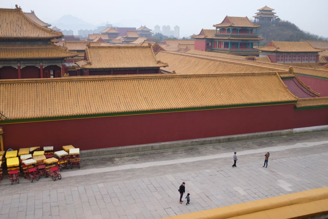Tourists explore a vast film set replica of Beijing's Forbidden City at Hengdian World Studios.