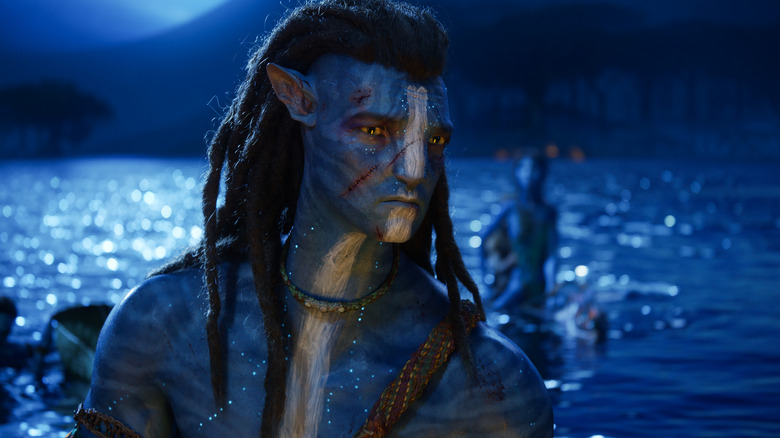 Sam Worthington as Jake Sully sitting in the ocean in Avatar: The Way of Water