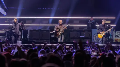 Getty Images Oasis tour photo, with the band on stage performing