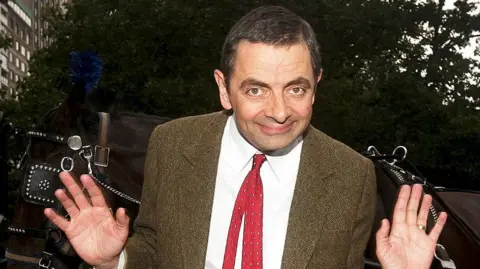 Getty Images Comedian Rowan Atkinson "Mr. Bean" poses with horse and buggy at 59th street and 5th avenue to promote his new Universal Pictures movie "Mr. Beans's Holiday" on July 19, 2007 in New York City.