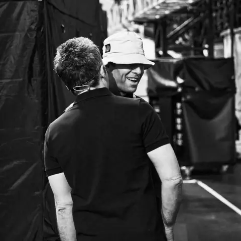 PA Media A backstage shot of Noel and Liam Gallagher chatting from their documentary, Oasis: Don't Look Back In Anger