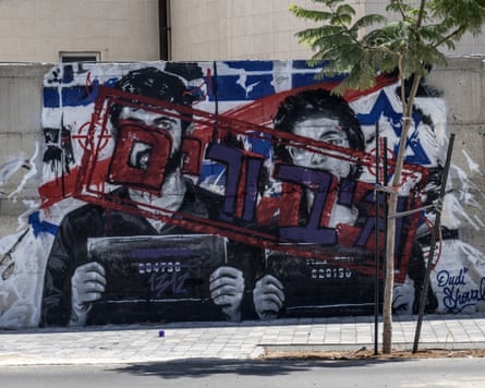 The mural depicting Israeli film-makers Yuval Abraham and Rachel Szor. Initially painted by an artist accusing the film-makers of being ‘traitors,’ the text on the mural was subsequently modified by another artist to read ‘heroes.’