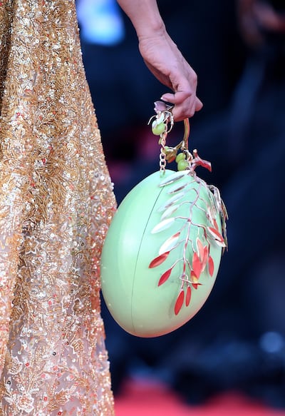 Kaouther Ben Hania carries an olive-themed bag as she arrives at the Venice Film Festival. EPA