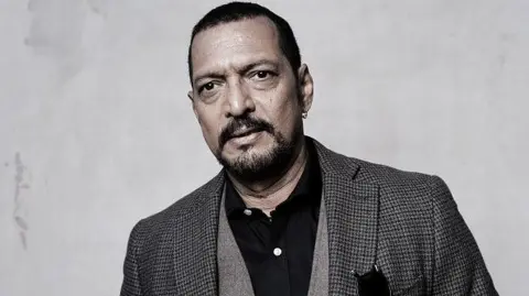 Getty Images A file photo of Nana Patekar wearing a check blazer with a black shirt
